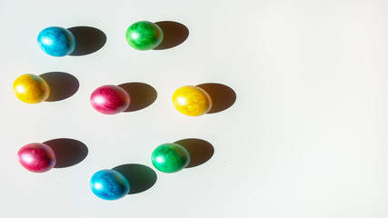 Colorful easter eggs on white background. Happy Easter composition. Copy space.