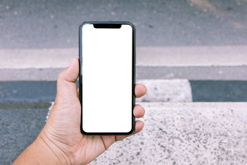 Asian man holding phone mock up left frame at footpath wait bus take to destination isolated display for insert screen
