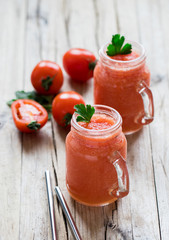 Vegan drink tomato smoothie with parsley in a jar on a wooden background in rustic style