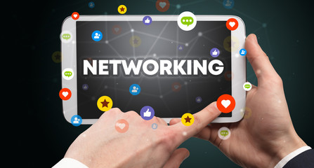 Close-up of a touchscreen with NETWORKING inscription, social networking concept