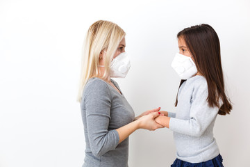 young mother wearing protective PM2.5 mask for her Daughter. isolated on white background.
