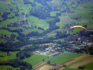 Épine mountain, France - August 5th 2008 : Focus on a orange paraglider in mid flight. We can see...