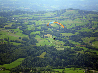 Épine mountain, France - August 5th 2008 : Focus on a blue and orange paraglider in mid flight. We...