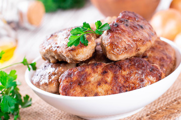 Fresh cutlets on plate on a table