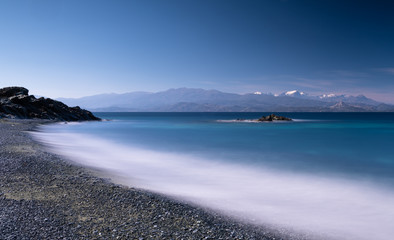 Black pebble beach and beautiful blue sea in the North of Corsica