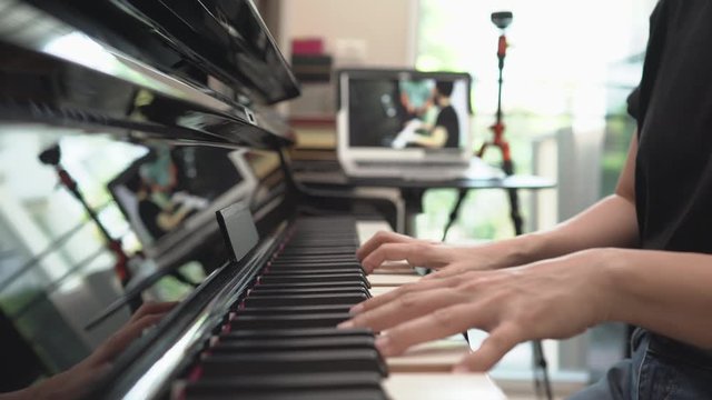 Online learning piano lessons, Online training or E-learning scene of instructor broadcasting class to network, vlog or teacher make online piano lesson to teach students pupils learn from home.