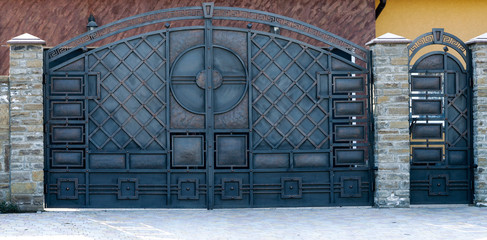 metal gates and doors with a black forged pattern.