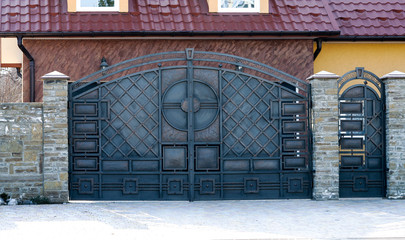 metal gates and doors with a black forged pattern.