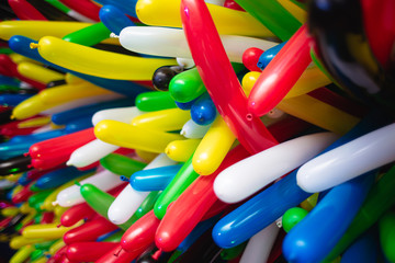 Background of multi-colored long balloons for a birthday party