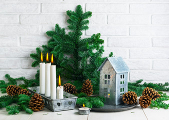 Christmas decoration with tin house and tin candlestick  and cones