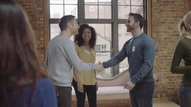 Group meeting at networking event and shaking hands