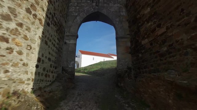 Entering through Evoramonte castle door. Drone shot revealing the interior of a Portuguese castle in Evora, Portugal