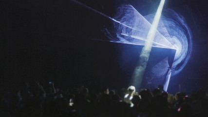 Laser Light Show in disco stage concert hall party music festival performance event. Laser rays are shine through the smoke.  DJ desk dico concert night club.