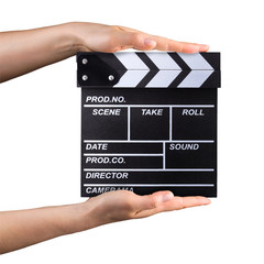Human hand holding film clapper board isolated on white background with clipping path
