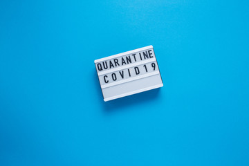 Inscription COVID-19 on blue background. Cube with the inscription. The inscription quarantine.