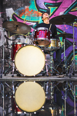 Fototapeta na wymiar Young man playing drums