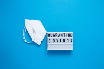 Inscription COVID-19 on blue background. Cube with the inscription. The inscription quarantine. The...