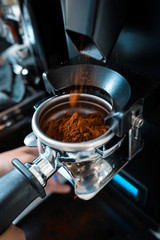 Barista making an espresso coffee with tamper
