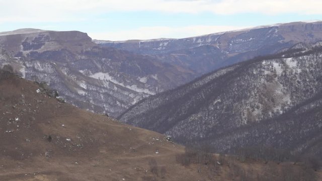 Giant ravines in the Northern foothills of the Caucasus. Rock outcrops occure, the slopes are covered with forest
