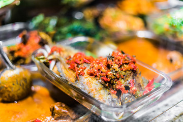 Traditional Asian dishes sold in a food court in Singapore
