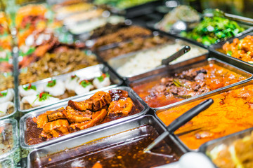 Traditional Asian dishes sold in a food court in Singapore