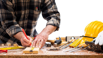 Close-up. Carpenter with pencil and the meter marks the measurement on a wooden board. Construction...