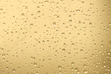 Water Drops./ Water drops on glass. Drops of water on a color background. Gold. Toned./Soft and...