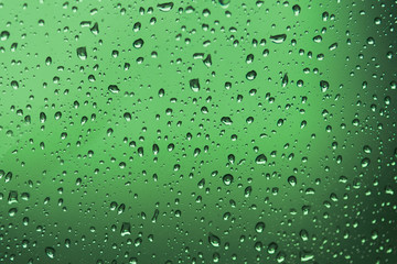 Water Drops./ Water drops on glass. Drops of water on a color background. Green/Gray. Toned.