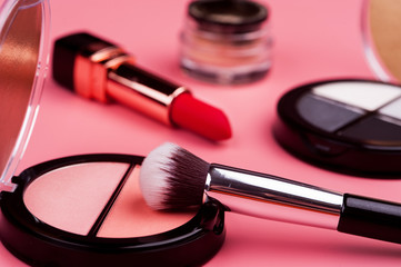 cosmetic products on a pink background