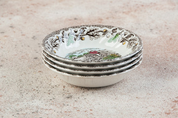 Four antique porcelain bowls on concrete