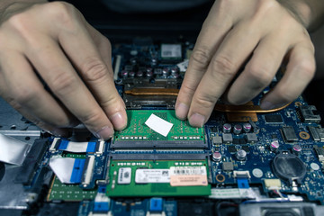 A close-up of an electrician repairing a computer circuit board,close up electrician hands are working with soldering iron