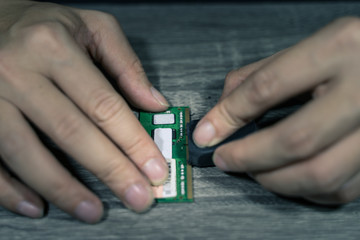 A close-up of an electrician repairing a computer circuit board,close up electrician hands are working with soldering iron