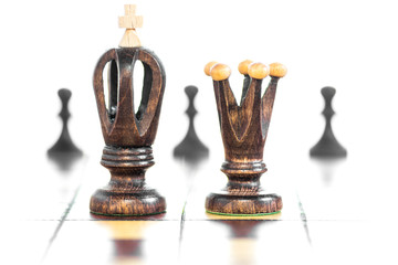 Chess game board with pieces of play on it. Selective focus of wood king and queen chess on board...