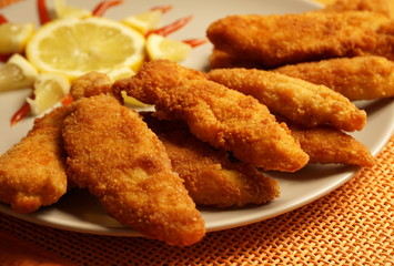 Fried chicken sticks, deep fried breaded chicken pieces close up