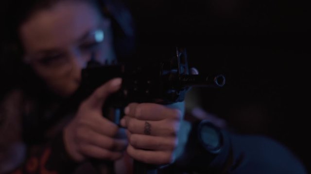Stock video footage firearm girl with a gun in the dash