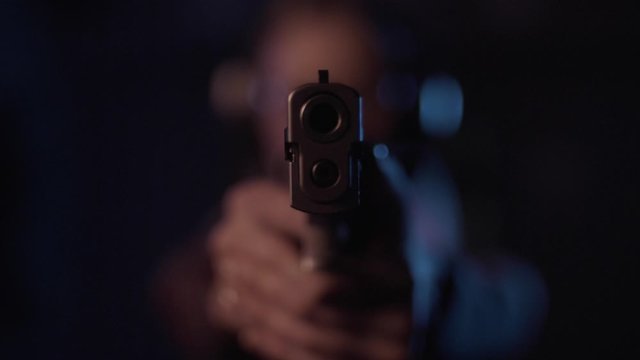 Stock video footage firearm firing of a gun in the dash