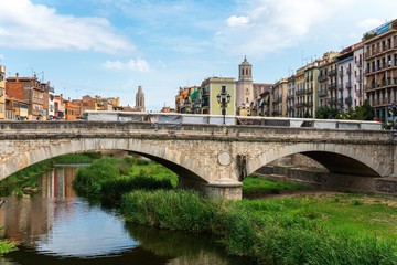 Girona, Spain, August 2018. View of the bridge across the moat and the architecture of the old city.