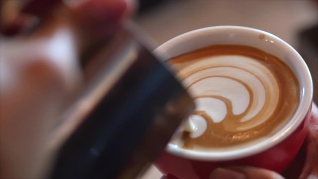 Barista Drawing Latte Art on Coffee with Soy Milk. Process of Making Vegan Lactose Free Drink in Coffeeshop. Professional barista.