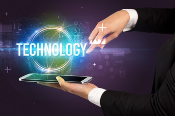 Close-up of a touchscreen with TECHNOLOGY inscription, new technology concept