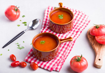 Delicious tomato soup on a light background.