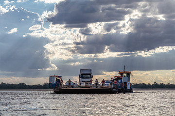 Ferry transports people and vehicles on the Araguaia River, uniting the Brazilian states of Tocantins and Acre.