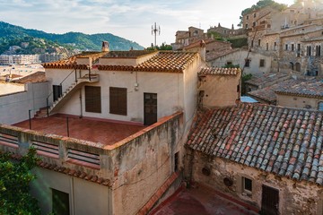 Fototapeta na wymiar Tossa de Mar, Spain, August 2018. The roofs of medieval houses in the old fortress.