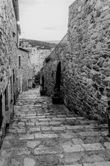 Tossa de Mar, Spain, August 2018. Black and white shot of a medieval street of the old city.