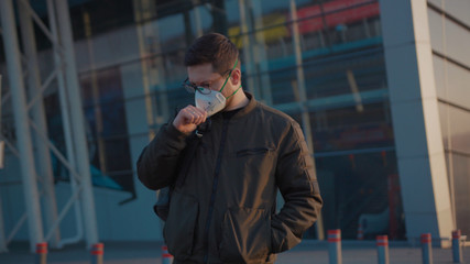 Close up man with backpack wearing Protective Face Mask walk COVID-19 coronavirus infection near airport pandemic disease virus male tourist epidemic air health illness slow motion