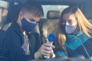  People gets body temperature measured with an infrared non-contact thermometer. Non-contact...