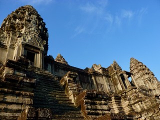 Stone temple with stairs of Angkor Wat with morning sun before blue sky, ruins of Angkor, Cambodia