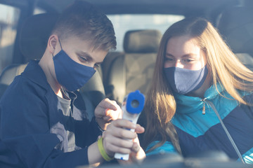  People gets body temperature measured with an infrared non-contact thermometer. Non-contact...