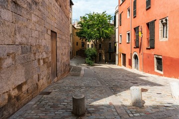 Fototapeta na wymiar Girona, Spain, August 2018. Scenic view of the medieval street of the old city.