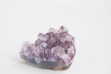 Large amethyst crystal close up photo. Natural stone isolated on light background.