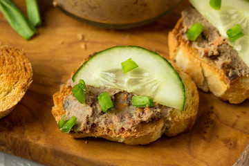 Homemade sandwiches with homemade chicken liver pate  on a cutting board.